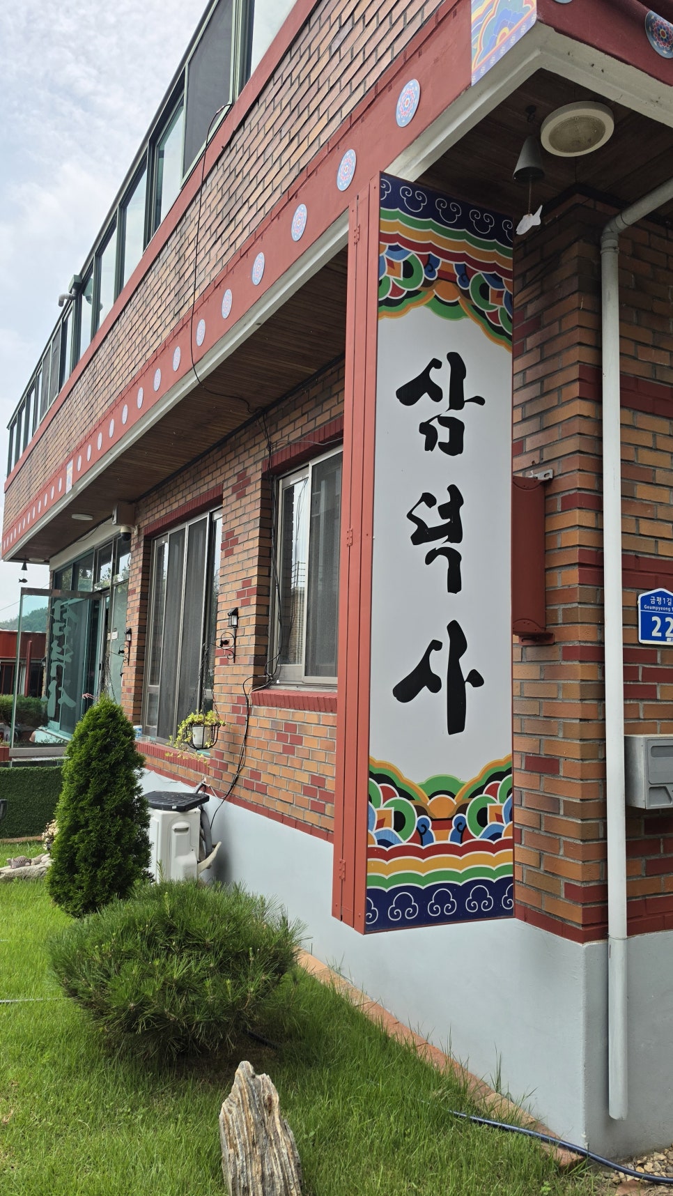 삼덕사 글자가 있는 벽면과 사찰 외부 건물
